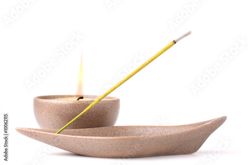 Candle and incense stick isolated on white background