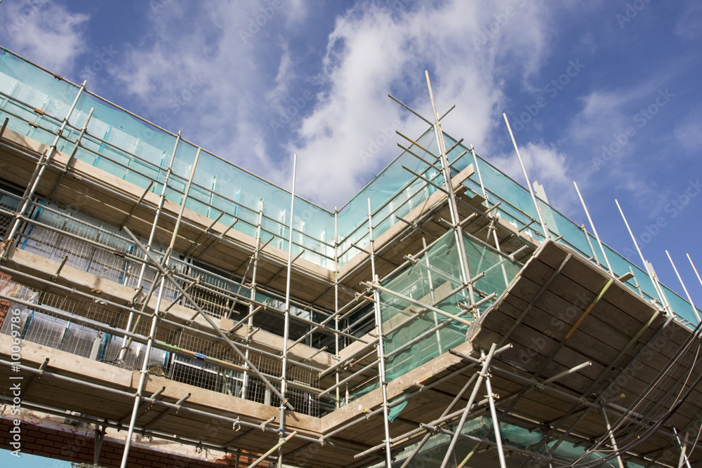 tall building scaffolding against a blue sky