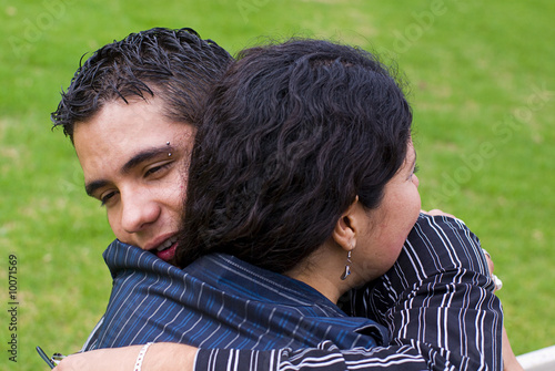 Woman and young teen son hug photo