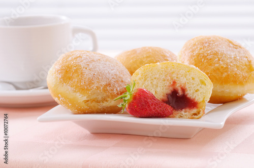 donuts with tea on pink tablecloth