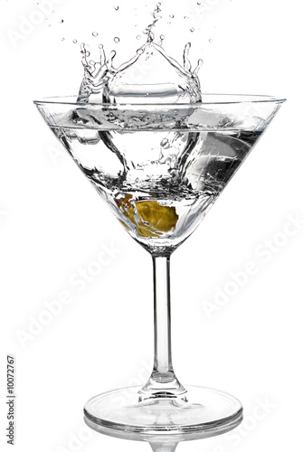 Olive splash into cocktail on white background