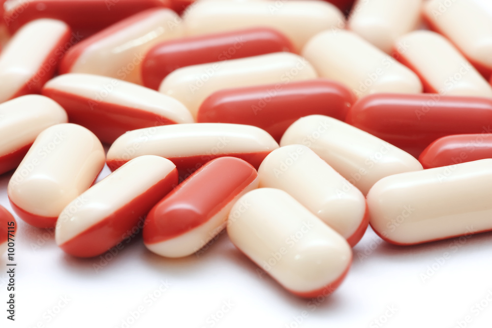 Closeup of red and white pills isolated on white. Closeup of red and white pills isolated on white.