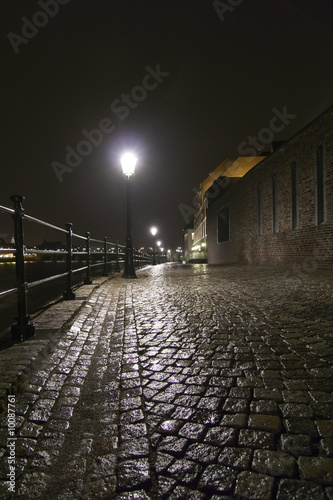Night shot of wet cobblestone road in Maastricht, Netherland.