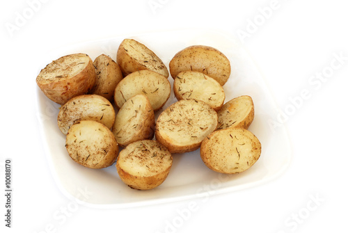 Roasted potatoes with rosemary on a plate isolated on white