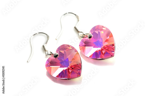 Fotografia A pair of pink earrings isolated on white background.