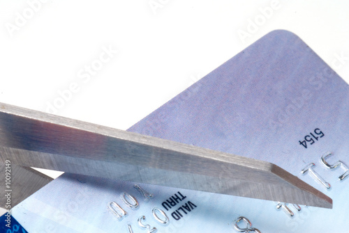 A consumer cutting an over the limit credit card.