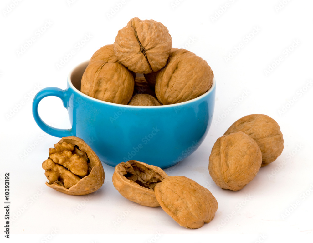 Walnuts in cup on white background Walnuts in cup on white background