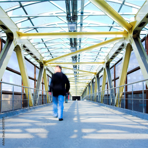 Yellow metal corridor with windows, crowd mooving