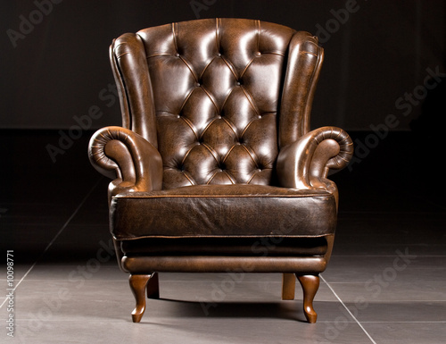 Fotografie, Obraz Brown leather armchair on a black background