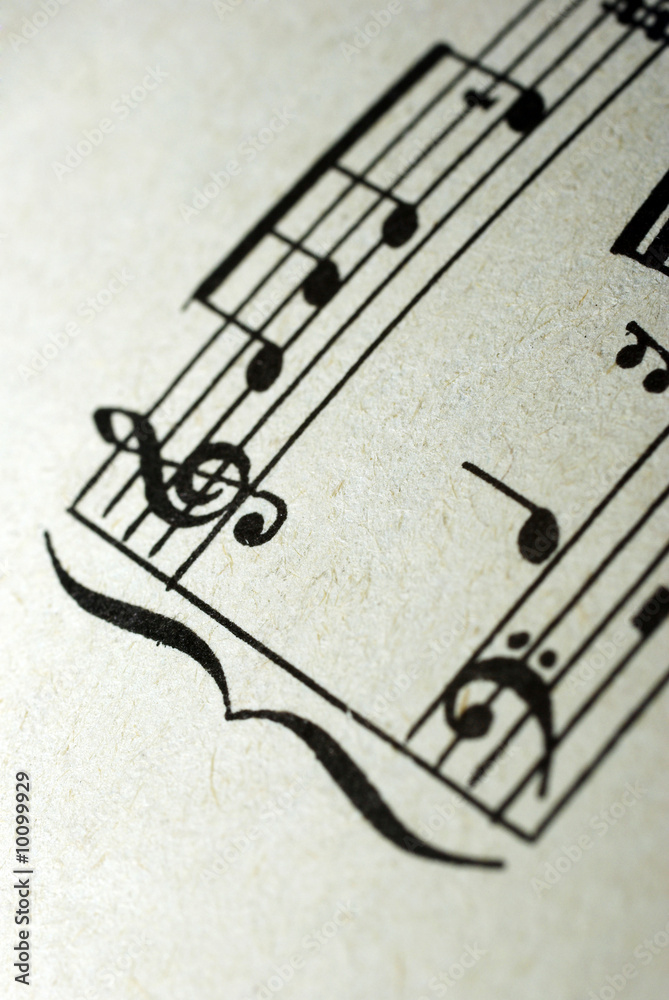 Fototapeta premium Sheet music notes on vintage paper background treble clef musical staff artistic close-up msuic vintge composition texture