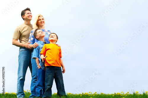 Happy family. Father, mother and sons in the park.
