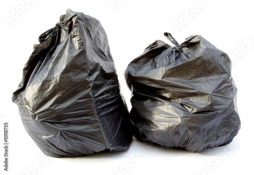 Two black garbage bags isolated on a white background