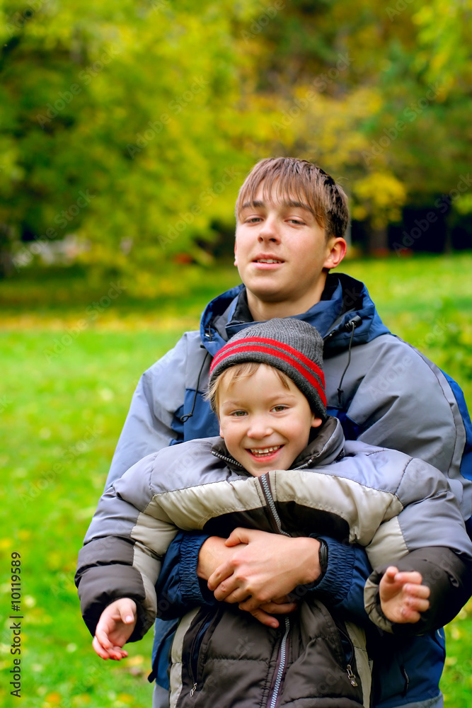 Fototapeta premium happy brothers stand in the park