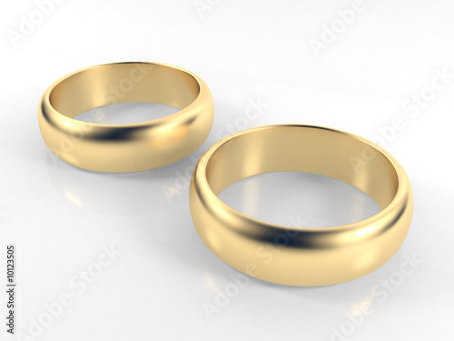 Isolated engagement gold rings on white background