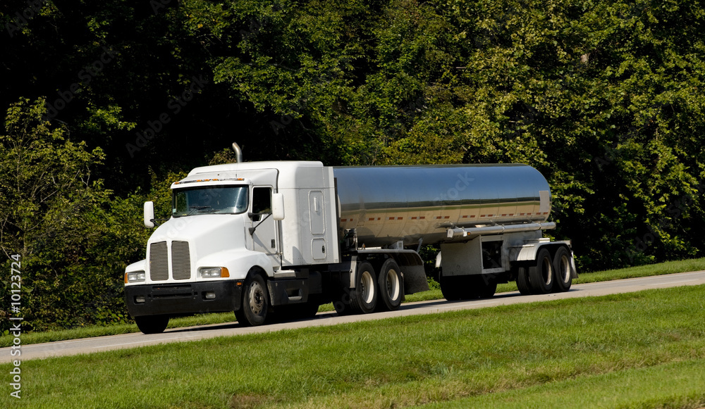 A fuel tanker transport truck on a highway, fuel transportaion