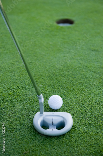 A short put in the game of golf with a ball and a putter