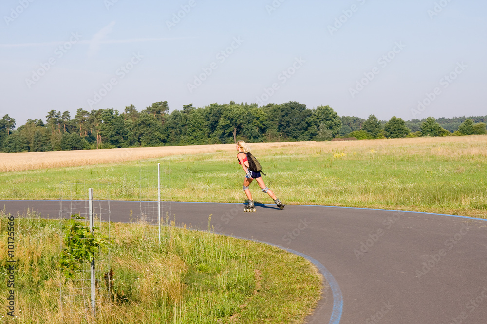 young female rollerskating on paved road