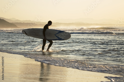 Photography surfer going in the sea