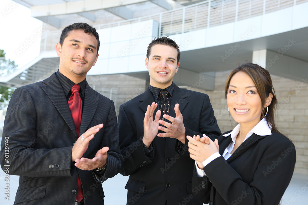 Attractive business team clapping (Focus on Man in Middle) Attractive business team clapping (Focus on Man in Middle)