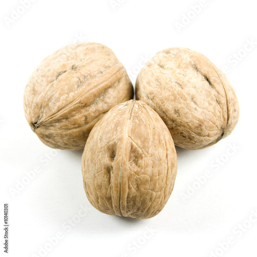 Three walnuts isolated on white.