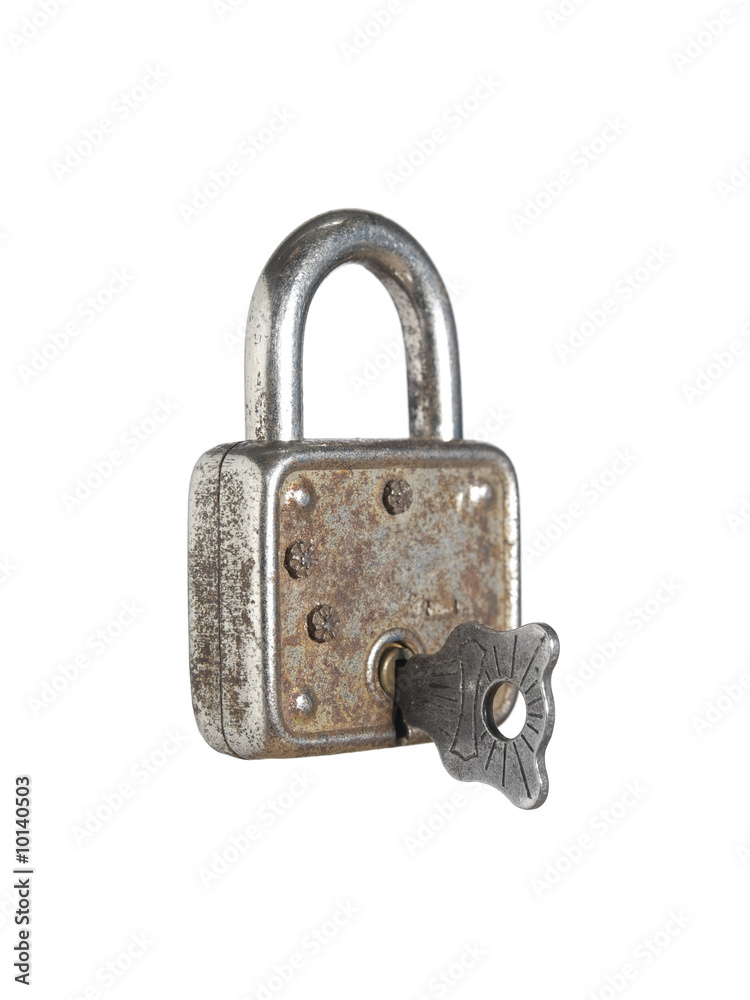A closed lock with a key isolated on white background. A closed lock with a key isolated on white background.