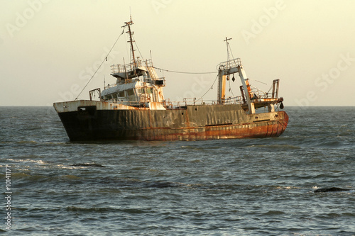 shipwreck at sunset in ocean