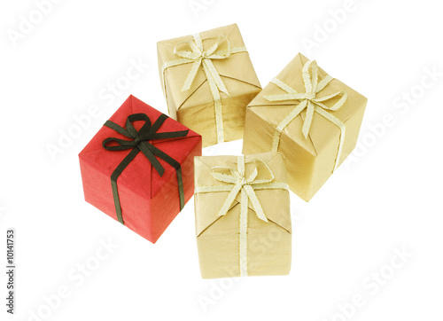 Red gift box among gold color boxes