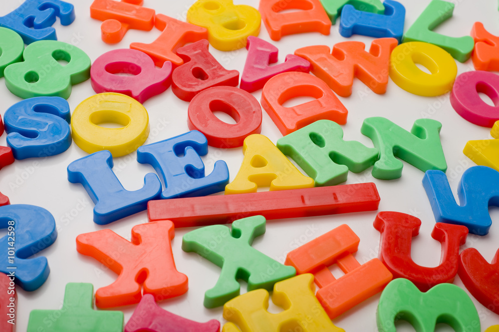 A colorful group of plastic letters spelling the word A colorful group of plastic letters spelling the word
