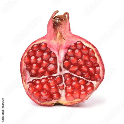 Half of pomegranate. Isolated over white.