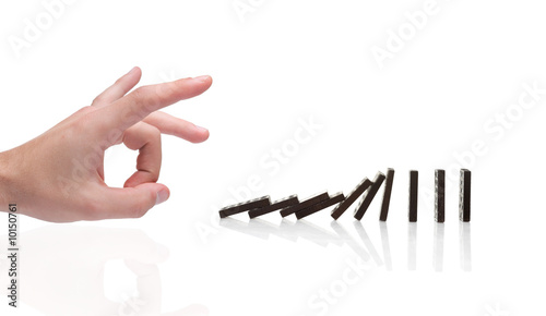 Obraz na plátně Person pushing domino blocks