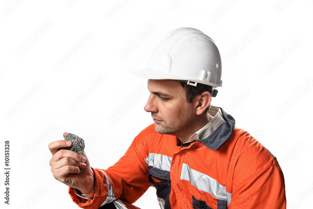 Mine engineer checking mineral isolated on white Mine engineer checking mineral isolated on white