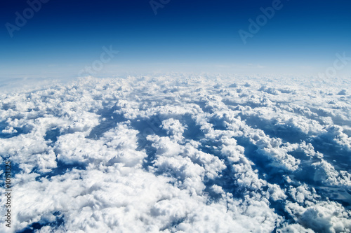 View from airplane window over the clouds