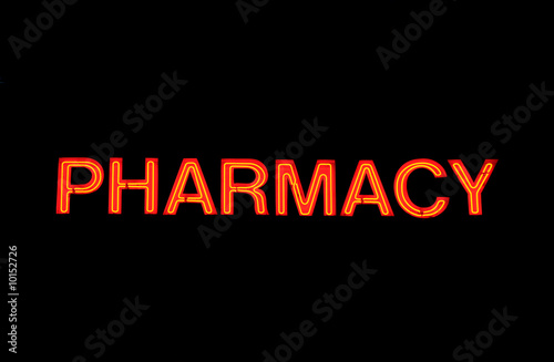 Neon sign with the word "Pharmacy" over black