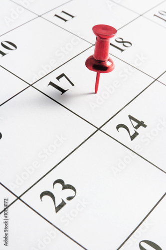 Red Thumb Tack on Calendar Page