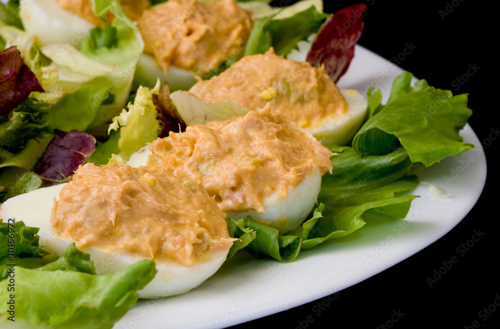 white platter with boiled eggs filled with tunna sauce white platter with boiled eggs filled with tunna sauce