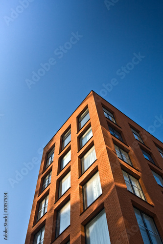 New office building with blue sky. Vertical background.
