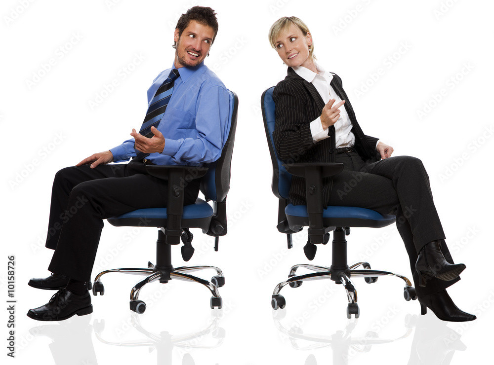 young business couple sitting on chairs and talking