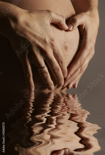 pregnant belly with a heart in water