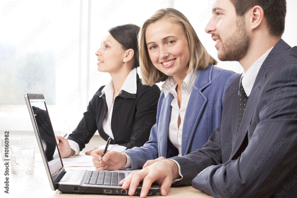Two businesswomen and a businessman working in team Two businesswomen and a businessman working in team