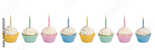 Cupcakes with candle border on white background