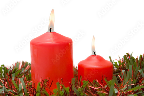 Red candles of Christmas lit on a over white background