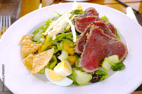 lunch salad with egg, mandarin, salad, sprouts, olives steak