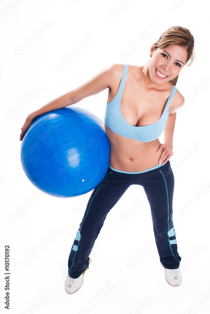 Young woman holding an blue exercise ball Young woman holding an blue exercise ball