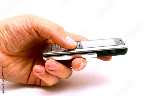 The hand of man holding the mobile phone isolated