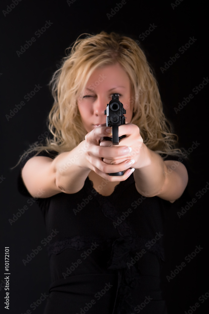 Girl aiming at a sight of a pistol