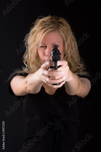 Girl aiming at a sight of a pistol