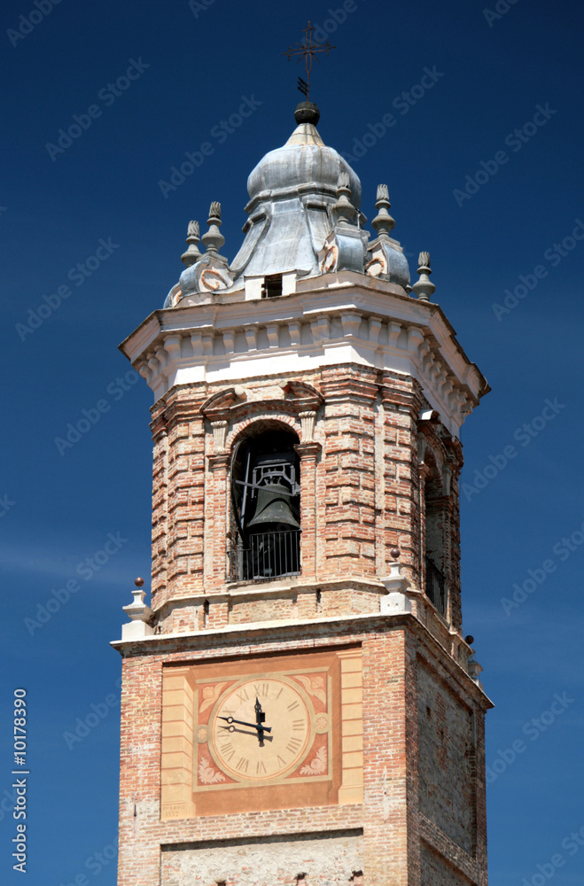 Fototapeta premium Medieval church clock and bell tower against blue sky