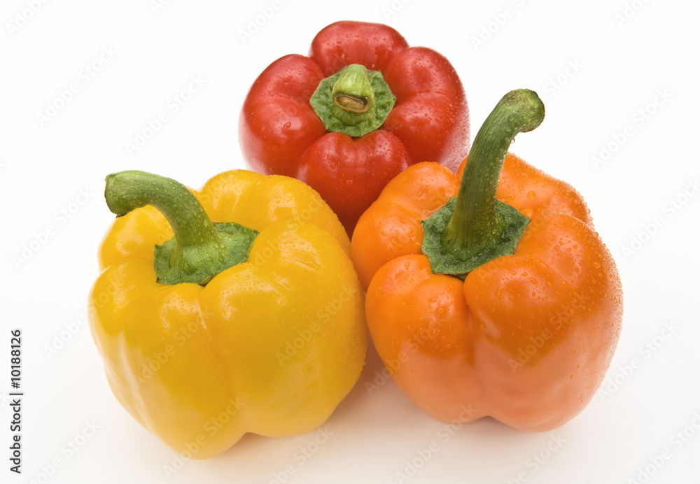 Red, orange, and yellow bell peppers on white background Red, orange, and yellow bell peppers on white background