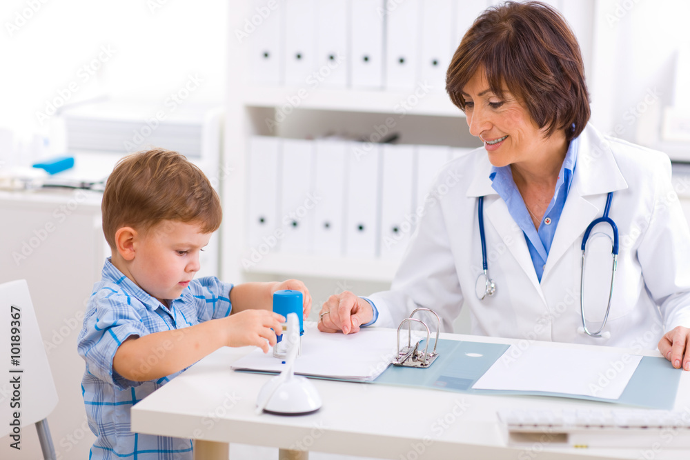 Senior female pediatrician playing with child Senior female pediatrician playing with child