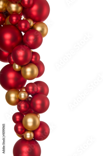 Hanging gold and red Christmas balls on white background